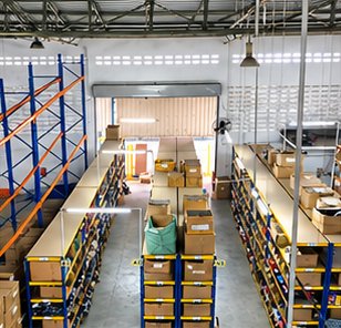 Warehouse aisle with racking and packing tables